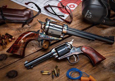 Photo of a Turnbull Ruger Super Blackhawk and a Turnbull Ruger New Bearcat, both featuring bone charcoal color case hardening