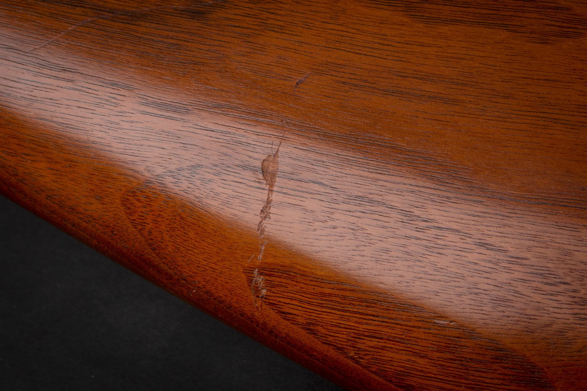 Photo of scratches on a pre-owned Winchester Model 12 pump action 12 gauge shotgun, sold as-is by Turnbull Restoration
