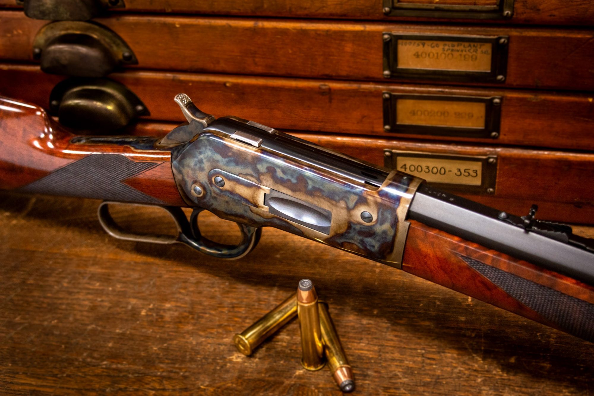 Photo of a Winchester Model 1886 reproduction by Turnbull Restoration, featuring period-correct color case hardening, charcoal bluing and rust bluing
