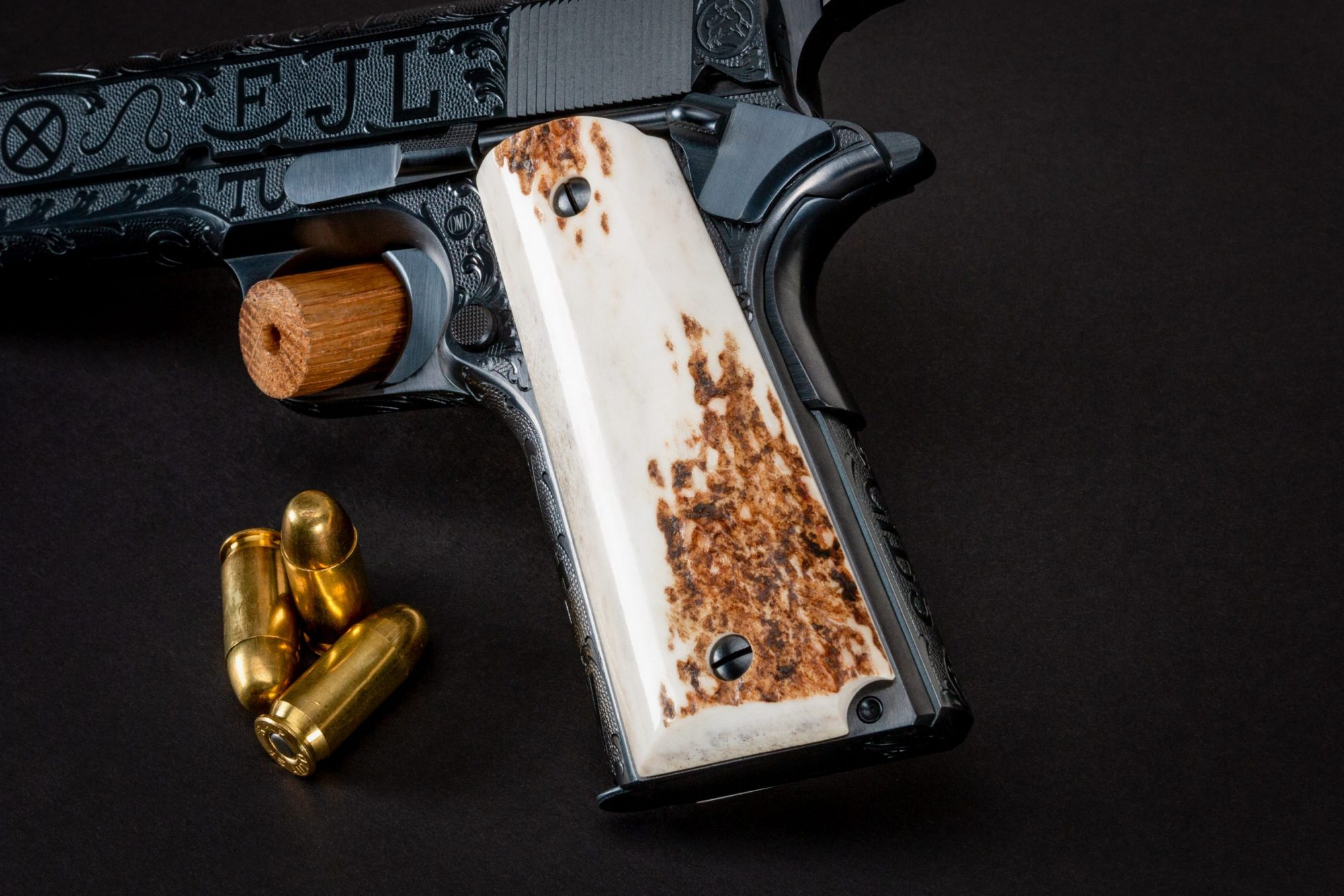 Photo of a Turnbull Restoration Model 1911, featuring cattle brand engraving and hand-fit elk grips