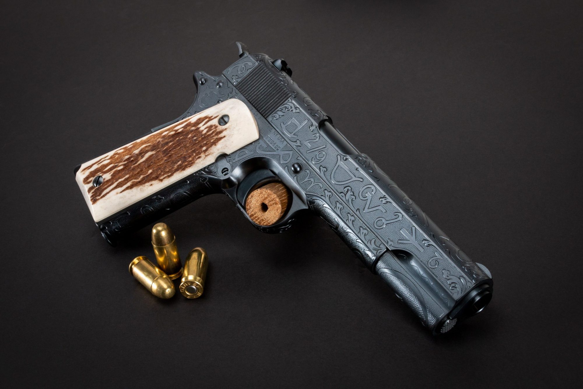 Photo of a Turnbull Restoration Model 1911, featuring cattle brand engraving and hand-fit elk grips