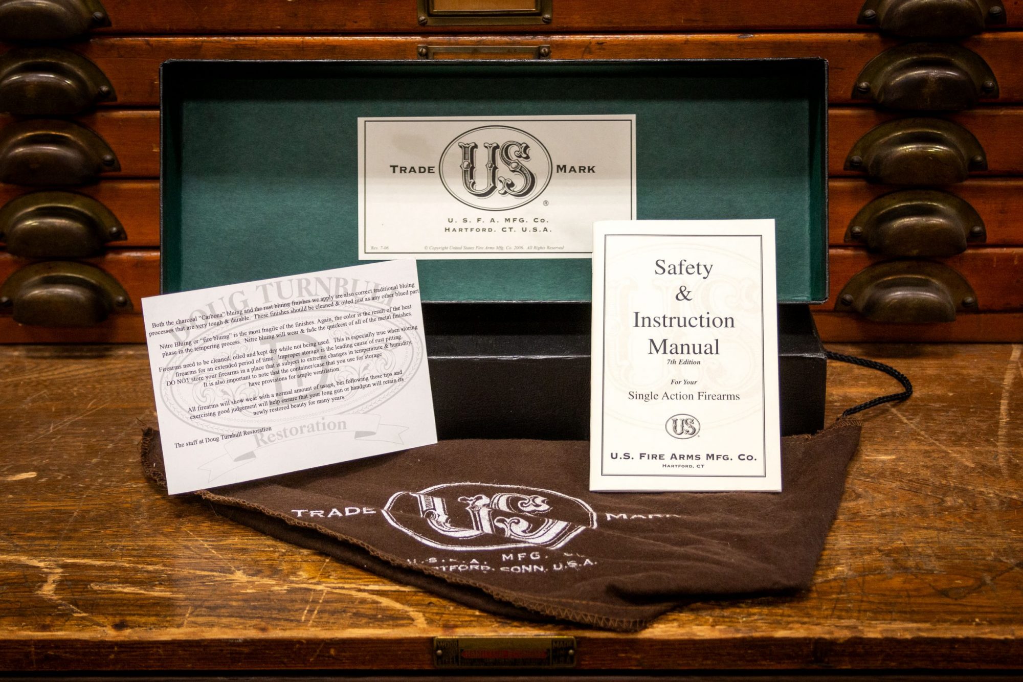 Photo of packaging for a U.S. Fire Arms SAA revolver in .45 Colt, featuring bone charcoal color case hardening by Turnbull Restoration of Bloomfield, NY