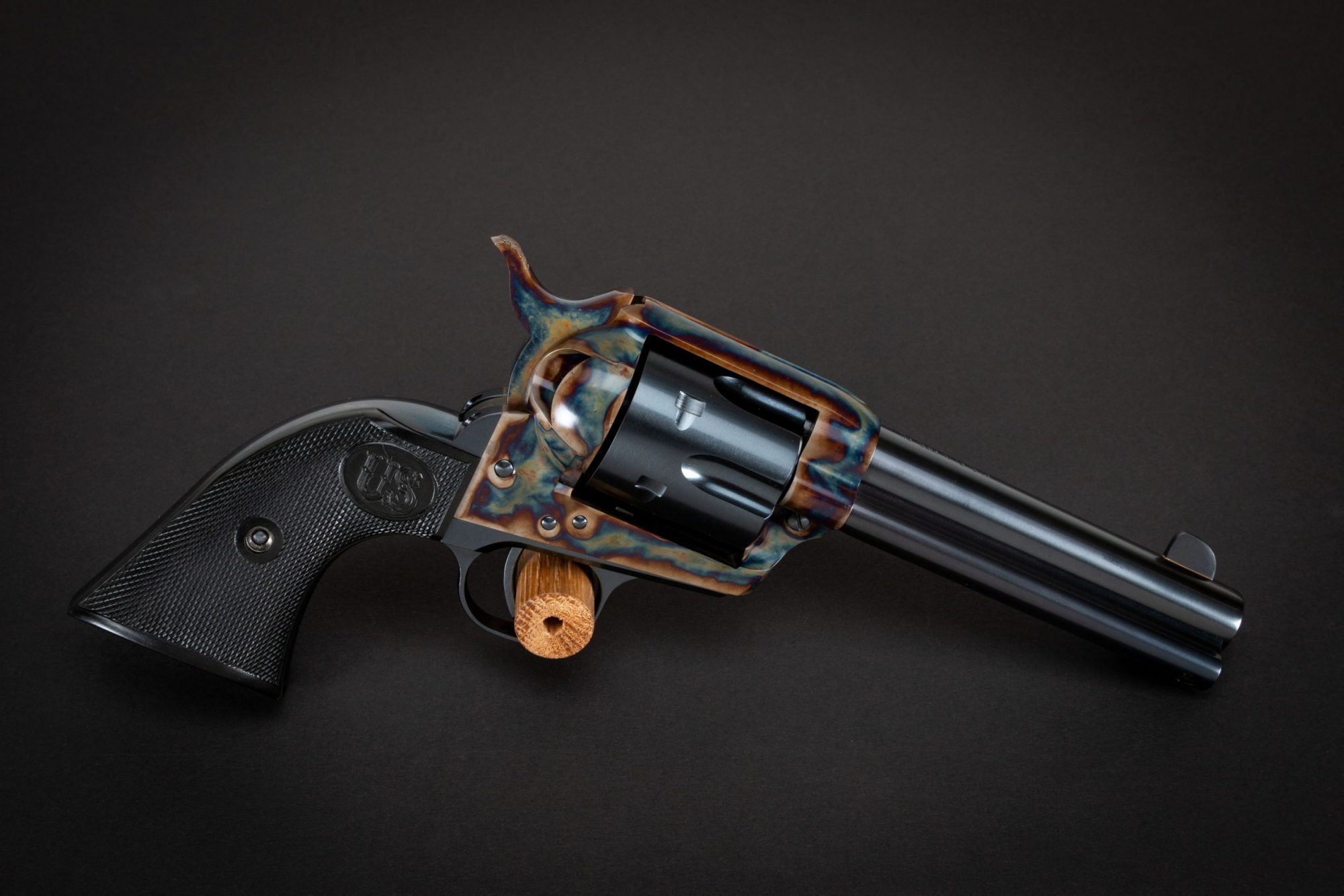 Photo of a color case hardened U.S. Fire Arms SAA revolver, featuring restoration-grade bone charcoal color case hardening by Turnbull Restoration of Bloomfield, NY