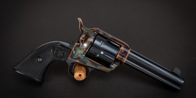 Photo of a color case hardened U.S. Fire Arms SAA revolver, featuring restoration-grade bone charcoal color case hardening by Turnbull Restoration of Bloomfield, NY